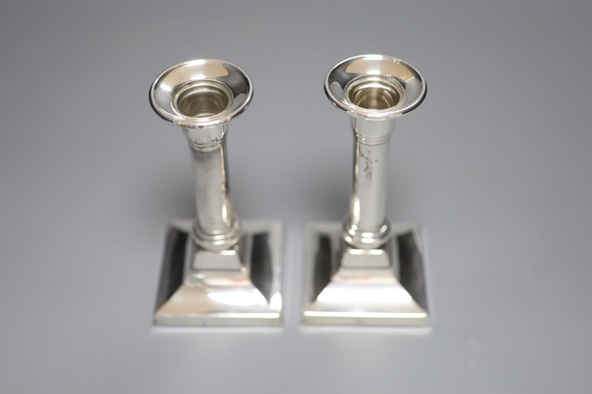 A pair of modern 925 sterling dwarf candlesticks, height 14.5cm, weighted.